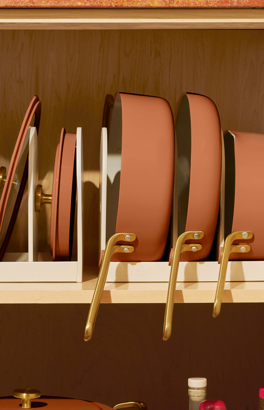 Our Place Essentials Pan Trio in Terracotta, three ceramic nonstick fry pans with glass lids and storage racks