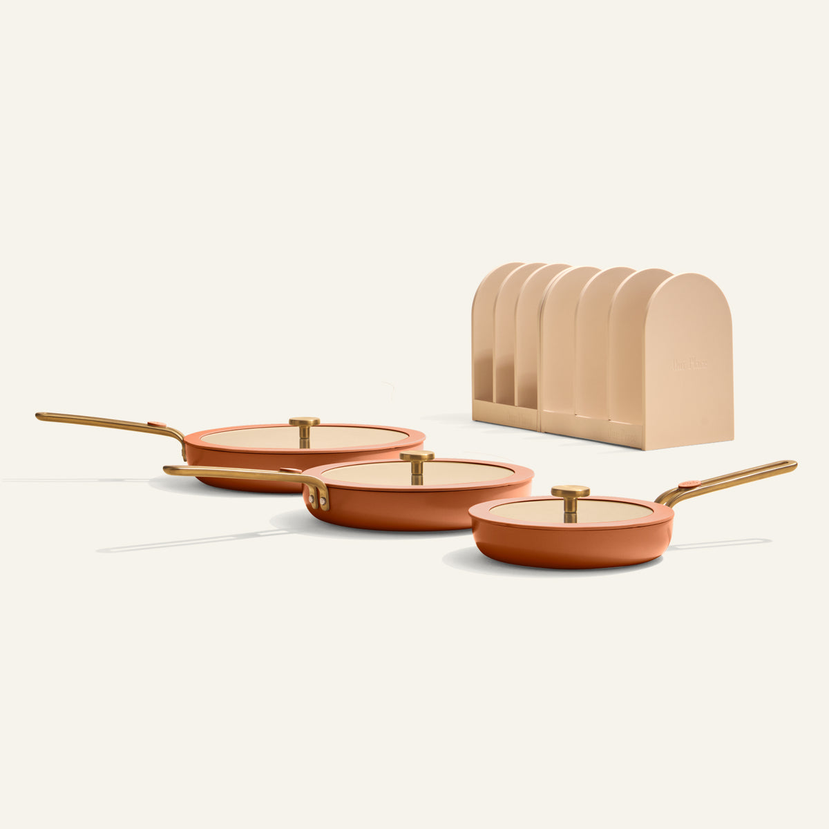 Our Place Essentials Pan Trio in Terracotta, three ceramic nonstick fry pans with lids and storage racks